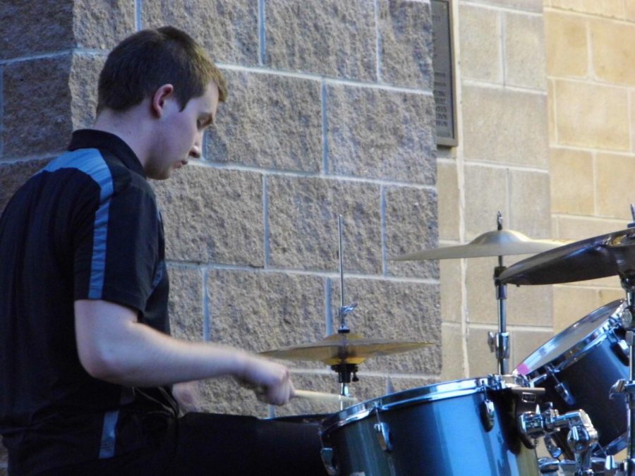Junior Grant Weishaar plays the drums to A Closer Walk with Thee.