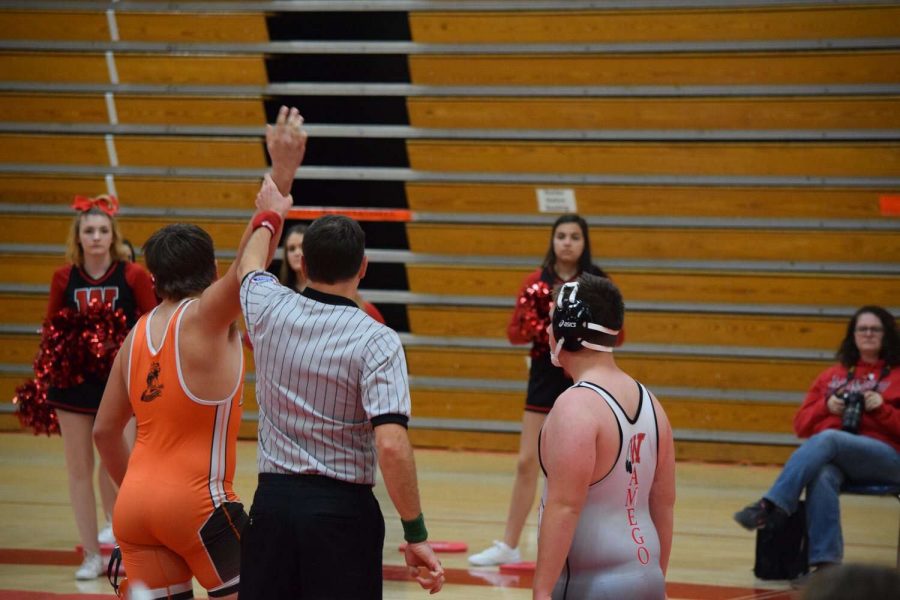 Cowboys Karsen Loader gets hand raised after a pin victory in Wamego.