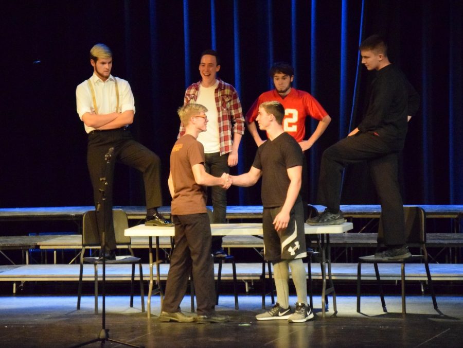Braydon (front left) shakes hands with Dakotah Whiteley during a skit based on a song featured in The Greatest Showman during the Fall 2018 vocal music concert. 
