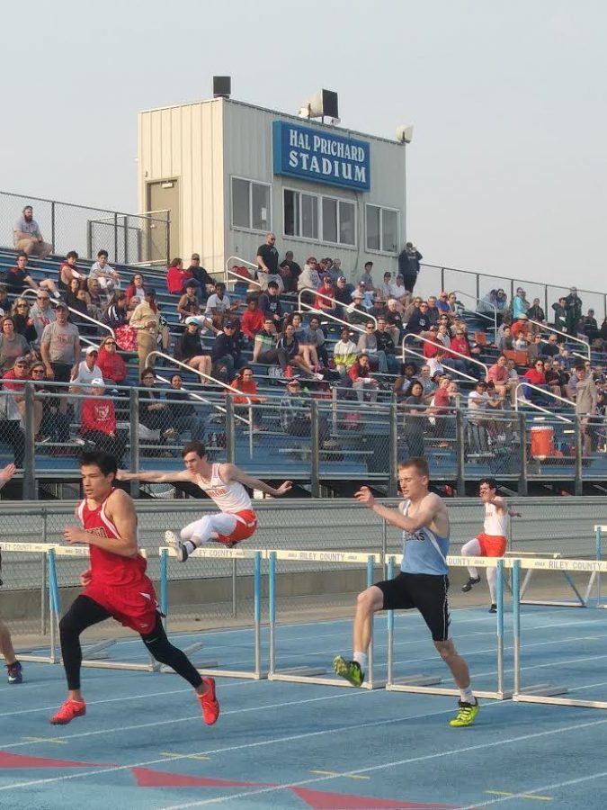 Triston Stover (left) leads Jonathan Ritchie (right) in a leg of the 110 meter hurdles at Riley County. 