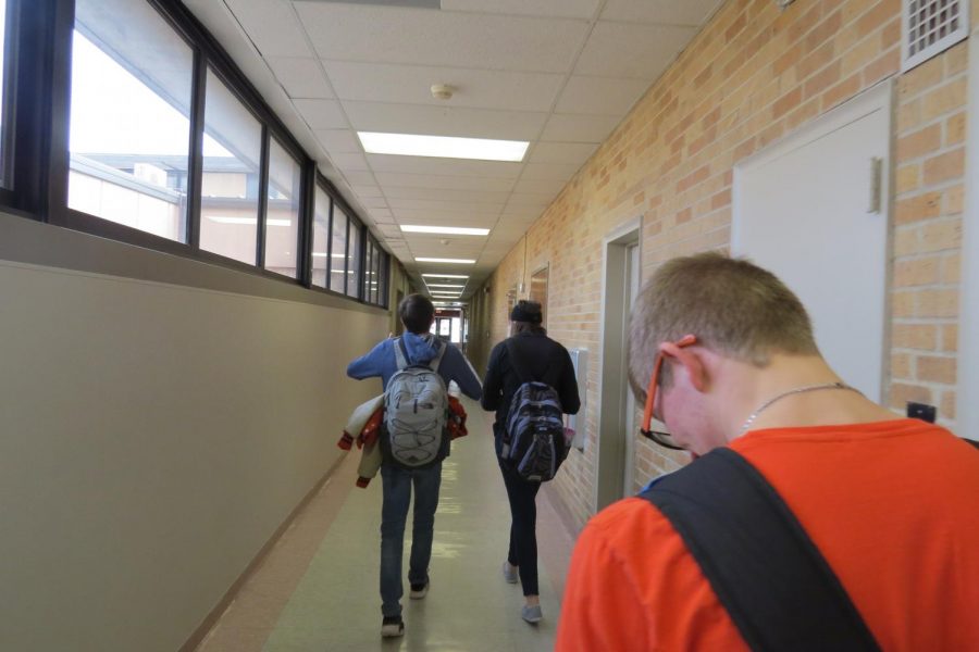 A few students (Dakota Morton, Trinnity McMillen, and Braydon Surritte) walk to their physics class. 