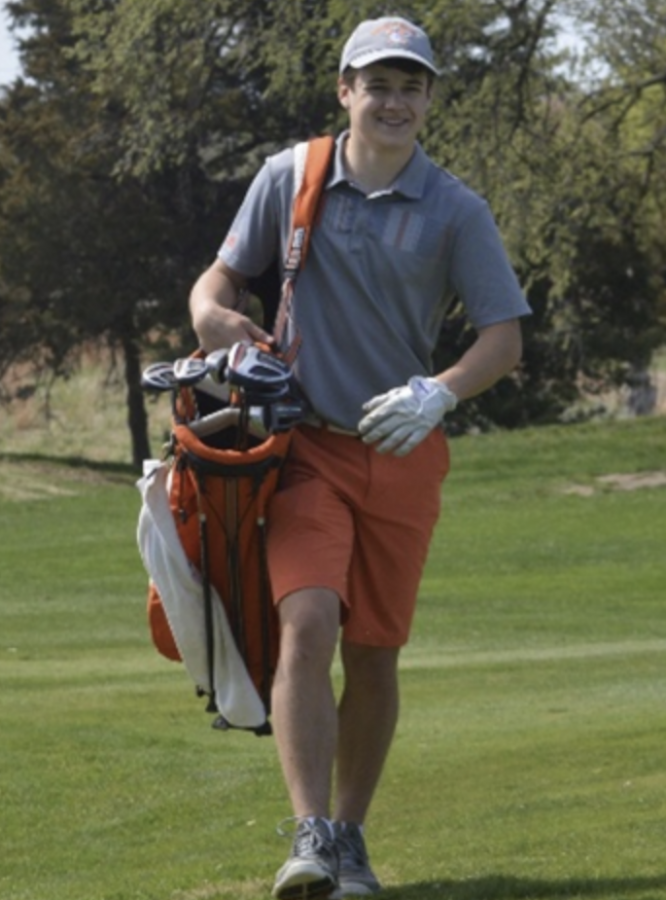 AHS Senior, Jimmie Brooks smiling while playing the home tournament his junior year.